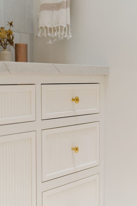 50/50 offset vertically stacked white tiled wall, custom reeded vanity with inset cabinets, quartz countertop, and brass hardware. #thedendesigngroup  #bathroomtile #bathroomdesign #designinspo  #luxegoldplumbing #luxurybathroomdesign #reededvanity #customvanity #cabinethardware #bayareainteriordesign #quartzcounter Reeded Vanity, Tiled Wall, Inset Cabinets, Custom Bathroom Vanity, Quartz Counter, Custom Bathroom, Custom Vanity, Quartz Countertop, Bathroom Design Luxury