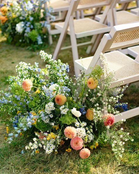 Beautiful blue, yellow, pink, and white flower arrangements lining the end of the wedding ceremony aisle. Floor Meadow Wedding, Wedding Aisle Garden, Flower Lined Aisle Wedding, Wedding Aisle Flowers On Ground, Aisle Meadow, Wedding Aisle Floral, Jake Photo, Nyc Editorial, Backyard Ceremony