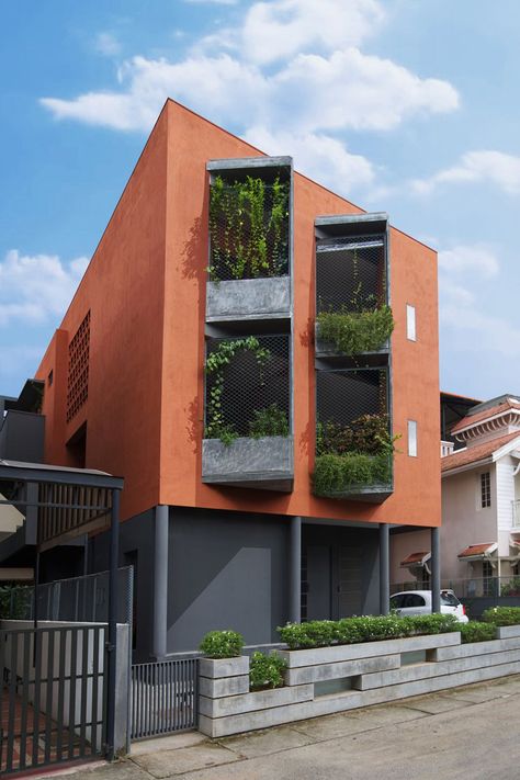 the advertising studio is distinct from the urban fabric as it is wrapped in a red skin and displays vertical garden balconies. Facade Architecture Design, Modern Architecture Building, Architecture Model House, Design Exterior, Building Facade, Apartment Garden, Building Exterior, Architecture Exterior, Facade Architecture