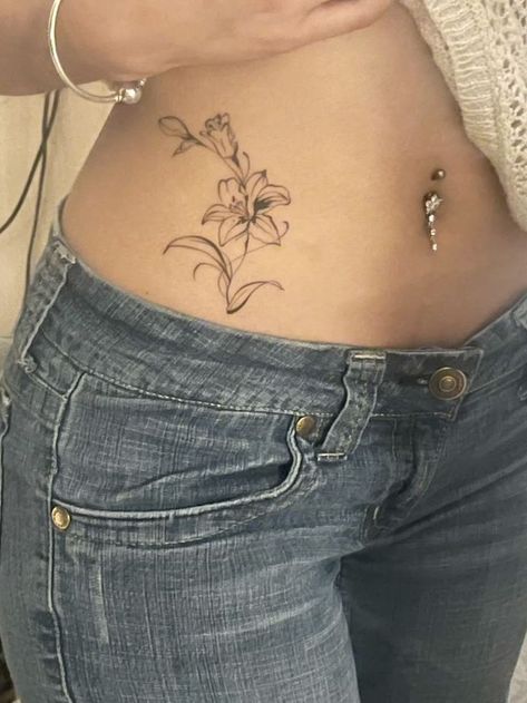 this is such a good placement too Tulip Back Tattoo Women, Lily Tattoo Stomach, Violet Hip Tattoo, Tattoo Ideas Lily Flower, Lily Stomach Tattoo, Dainty Side Tattoos For Women, Lilly Hip Tattoo, Lily And Tulip Tattoo, Flower Semi Colon Tattoos