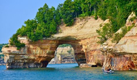 a boat in the water heading to an arch in a sandstone cliff Pictured Rocks Michigan, Munising Michigan, Pictured Rocks, Pictured Rocks National Lakeshore, Us Road Trip, Michigan Travel, Sea Kayaking, Us National Parks, On The Road Again