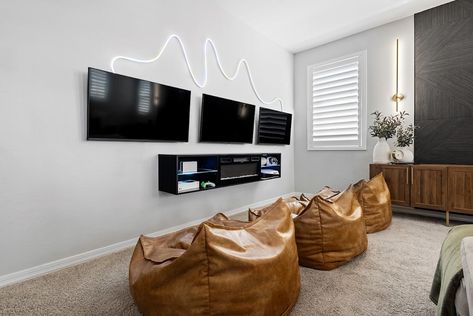 A moment for this loft. We created a more formal living room in their downstairs space, so the family wanted the upstairs loft to be for comfy family movie nights, toy storage, and the boys’ video games. We created of theatre vibe with the LED sconces and beautiful textured feature wall completed by @reimagined_hi (they also installed surround sound for the ultimate movie viewing experience) We added THREE media consoles together to create the perfect supersized media center with maximum t... Family Movie Room, Textured Feature Wall, Media Consoles, Upstairs Loft, Rv Homes, House Loft, Formal Living Room, Family Movie, Family Movie Night