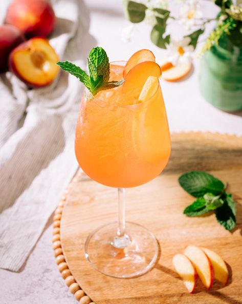 Aperol + Peach Spritz (Easy 4 Ingredient Recipe) - The Social Sipper Peach Aperol Spritz, Sweet Aperol Spritz Recipe, Peach Spritz, Aperol Spritz Mock Tail, Wine Spritzer Recipe, Apperal Spritz Recipe, White Wine Spritzer, Spritzer Recipes, Wine Spritzer