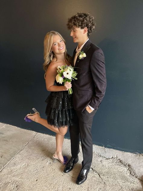 homecoming, couple, relationship goals, black hoco dress, black hoco, purple heels, homecoming bouquet, candid Prom Bouquet Black Dress, Purple Homecoming, Black Prom Dress Couple, Purple Hoco, Prom Bouquet, Purple Heels, Black Prom Dress, Purple Accents, Cute Prom Dresses