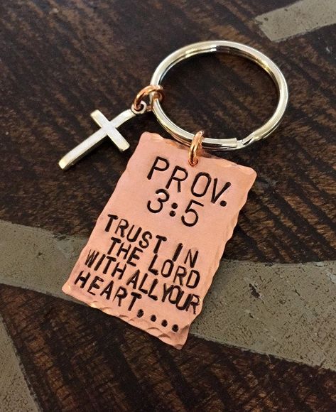 "Proverbs 3:5 Keychain Trust in the Lord With all your Heart Christian Keychain Copper Keychain Handstamped Keychain Christening Gift This handstamped Proverbs Keychain will make the perfect gift.This has the amazing Proverbs 3:5 handstamped. This listing includes: * 1.5\" Copper Keychain handstamped with \"Proverbs 3:5\" * Silver Cross Samples shown are stamped in 6mm Sans Serif This keychain can be customized in any manner All handstamped items are wrapped nicely in gift packaging. Every piece Christian Keychain, Christian Accessories, Christian Shirts Designs, Christian Merch, Christian Quotes God, Hand Stamped Keychain, Trust In The Lord, Christian Bible Quotes, Proverbs 3