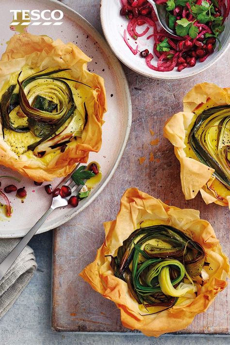 These elegant tartlets are great for plating up as a starter. A savoury filling of creamy goat's cheese and tender charred leeks is encased in a floral-shaped crisp filo pastry cup for a simple yet stunning veggie dish. | Tesco First Course Ideas, Savoury Tart Recipes, Cheese Tartlets, Tart Recipes Savory, Tartlets Recipe, Course Ideas, Tesco Real Food, Bruschetta Recipe, Easy Cheese