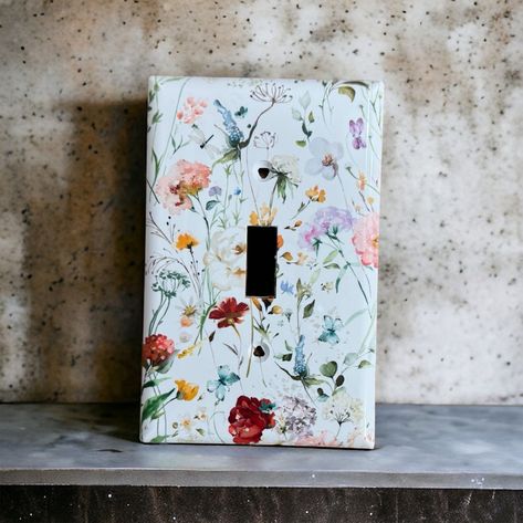 These custom wild flower light switch covers are made to order. Give your house an extra touch of character or flare.  Each switch cover is handmade using premium materials that will last and are easy to clean. The screws will also come printed so they will match the cover.  If you have a custom print you would like done please reach out to me via Etsy messages and I will be happy to help you. Outlet Painting Ideas Easy, Pond Bathroom, Cute Light Switch Covers, Forestcore Bedroom, Kelsey Core, Outlet Painting Ideas, Flower Light Switch, Dresser Painting, Sf House