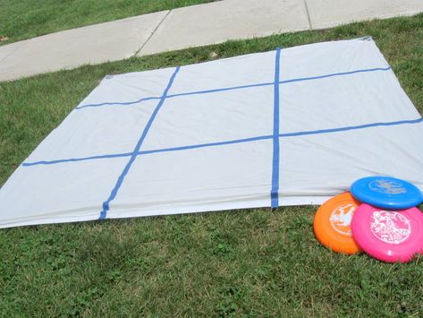 Frisbee Tic Tac Toe  Get a shower curtain from Dollar Tree and we use cheap tape to make a Tic Tac Toe grid.  Set 6 frisbees out and have the kids stand behind a line and see who had the best aim!  Would be so easy to incorporate core subjects-! Outside Games, Reunion Games, Fun Outdoor Games, Reunion Ideas, Relay For Life, Camping Games, Yard Games, Backyard Games, Carnival Games