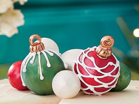 Cake Ball Ornaments Recipe | What better way to top a Southern Living white cake than with these festive cake balls. These charming (and edible) ornaments can be colored however you wish with melted candy coating disks. You’ll need about 1 1/2 pounds of disks to cover 20 cake balls. Add Luster Dust in the ornaments’ colors for a sparkly finish, if desired. Top this year's Snowy Vanilla Cake with these ornaments we can't guarantee they will make it to dessert. Edible Ornaments, Christmas Ornament Cake, 20 Cake, Melted Candy, Ornament Cake, Edible Luster Dust, Soda Cake, Cake Ball, Vanilla Cake Mixes