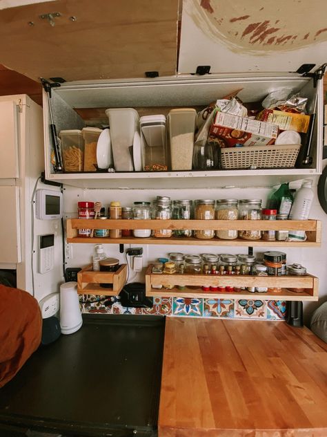 This blog post showcases what organization we use for our kitchen in our self converted campervan #vanlife #campervan Vanlife Kitchen Storage, Van Life Kitchen Storage, Van Shelf Storage, Campervan Kitchen Storage Ideas, Caravan Kitchen Storage Ideas, Campervan Kitchen Storage, Vanlife Bookshelf, Campervan Shelves, Vanlife Organization