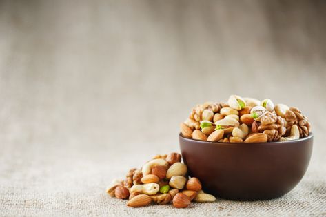 Mix of different nuts in a wooden cup ag... | Premium Photo #Freepik #photo Dry Fruit Photography, Different Nuts, Assorted Nuts, Best Food Photography, Dried Fruit Mix, Healthy Nuts, Wooden Cup, Nut Snacks, Pistachios Nuts