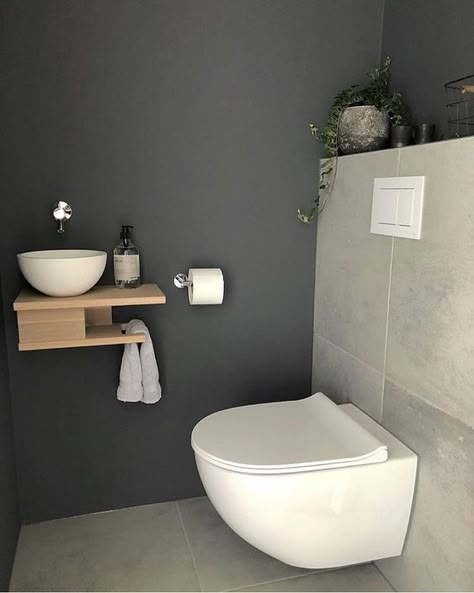 a tiny guest toilet with stone tiles, a wall-mounted wooden vanity with a vessel sink and a potted plant - DigsDigs Small Toilet Design, Toilette Design, Wc Design, Small Toilet Room, Finished Bathrooms, Guest Toilet, Small Toilet, Downstairs Loo, Downstairs Toilet