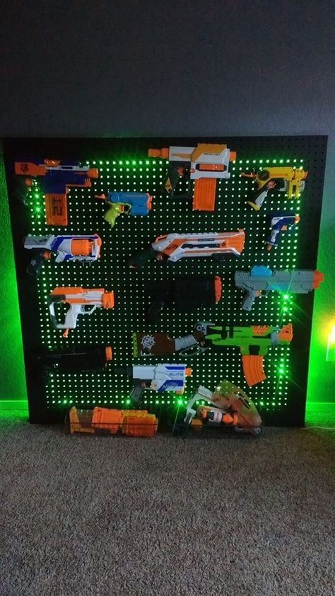 Nerf storage solution created by mom & dad Best Gamer Desk, Shelving For Electronics, Play/game Room Ideas, Ninja Room Ideas, Men’s Gaming Room Ideas, Gaming Room Kids Boys, Action Figure Storage For Kids, Nerf Fun Wall, Minecraft Playroom Ideas