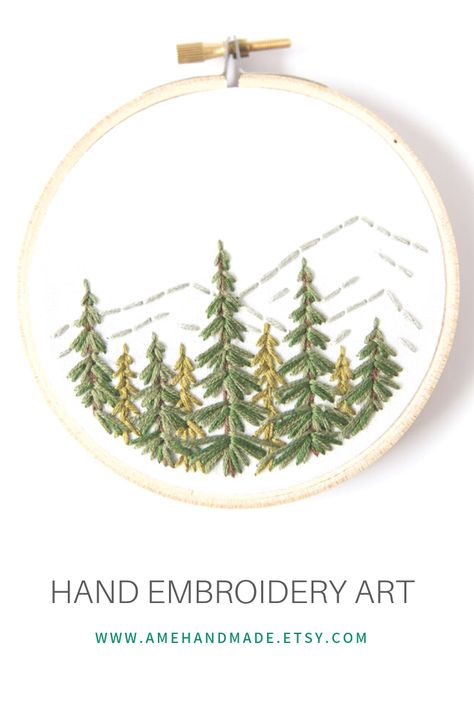 Want a unique piece of art to hang on your gallery wall? This charming embroidered forest and mountain scene is the perfect addition! All stitched by hand, this will pair perfectly with your art collection. How To Embroider Pine Trees, Pine Tree Embroidery Simple, Embroidery Outdoorsy, Embroider Evergreen Trees, Embroidery Evergreen Tree, Pine Tree Embroidery, Mountain Embroidery, Embroidery Trees, Pine Tree Wall