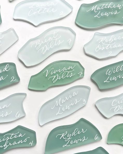 Escort cards from nature 🌿 Easy DIYs that bring the outdoors in! 🐚 Click the link in our bio for 13 stunning styles to inspire: https://onefabday.com/inspired-by-nature-13-diy-escort-card-ideas/ Photo 1: ✍️ by @writtenwordcalligraphy 📸 by @josevilla Photo 2: ✍️ by @krisannaelizabeth Photo 3: Cards by @lumacapaper Photo 4: ✍️ by @nobhilljane Photo 5: Pinecone cards by @thehappyhourhostess 📸 by @emilygibbyphotography #onefabday #escortcard #placecards #weddingdecor #weddingideas #nature Seaside Theme Wedding, Sea Glass Name Cards, Elegant Ocean Wedding, Sea Glass Place Cards, Sea Glass Name Cards Wedding, Coastal Place Cards, Sea Glass Place Cards Wedding, Seaglass Place Cards, Green Coastal Wedding