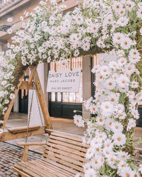 | DAISY • Marc Jacobs Daisy swing installation at @coventgardenldn . • @earlyhoursltd installation • A daisy themed transformation of the… Daisy Wedding Theme, Daisy Marc Jacobs, Themed Wedding Decorations, Daisy Wedding, Wedding Arbour, Marc Jacobs Daisy, Wedding 2025, Daisy Chain, Baby Party