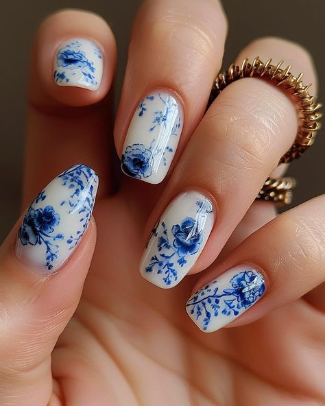 A photo of beautiful woman’s hand with white and blue porcelaininspired nail art, featuring intricate patterns inspired by classic Chinese ceramic designs. #floralnails #flowernails #summernails #springnails #thegelbottleinc #thegelbottle #biab #nailart #detailednailart Blue Rose Nails Design, White And Blue Floral Nails, Ceramic Nails Design, China Plate Nails, China Pattern Nails, White Nails Blue Design, Chinoiserie Nails, Blue Porcelain Nails, Blue And White Nails Simple