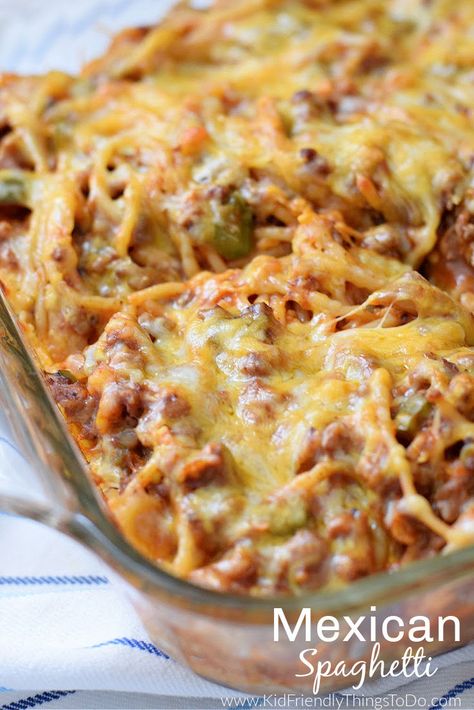 This Mexican Spaghetti Recipe is a delicious casserole style taco pasta bake. Filled with Mexican flavors, ground beef cooked in tomato sauce, spices and spaghetti noodles, layered with cheese and baked for a favorite family Mexican meal. Perfect for holidays and busy nights. www.kidfriendlythingstodo.com Taco Pasta Bake, Mexican Dip Recipes, Mexican Spaghetti, Baked Tacos Recipe, Layered Dip Recipes, Mexican Casserole Recipe, Mexican Casserole, Taco Pasta, Spaghetti Recipe