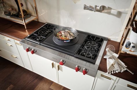 A new item in the Wolf lineup is our sealed burner rangetop, with a wok burner and 4 burners(48") or 2 burners(36"). It aptly handles the gamut of wok cooking techniques with equal precision, from searing highs of 35,000 Btu to simmering lows of 3,500 Btu.  Porcelain-coated cast-iron wok ring cradles a traditional round-bottom wok, offering extreme pan maneuverability and ability to angle the pan towards the cook for convenient access to contents. Wok Kitchen Design, Wok Stove, Glass Front Refrigerator, Kitchen Burner, Wok Kitchen, Wolf Oven, How To Clean Burners, Wok Burner, Wolf Range