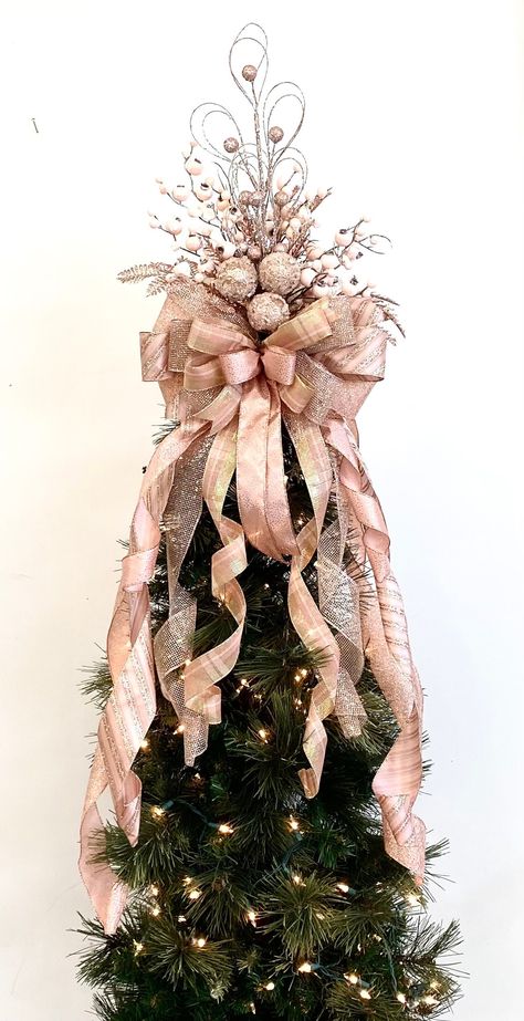 "Top your tree with this Pink Christmas design. Rose gold, dusty pink, mauve, glitter stripe colors. Ribbons  measure 2.5\" wide mixed with matching 1.5\" wide with wired edges for easy fluffing. The ends of tail streamers are straight for easy curling. Snow covered pink berries, iced ornaments in center. Glitter branches look great at night too.  This Pink Christmas design looks great on real or artificial trees, use on a large wreath, staircase, swags. It is handmade. Measures  14\" wide x 16\" long plus 10 tail/streamers that vary in length to 36\". This is a one sided design and flat on back. If you need it to look good all around your tree- Buy 2." Rose Gold And Leopard Christmas Tree, Pink Black Silver Christmas Tree, Christmas Tree Ideas 2023 Trends Pink, Pink Christmas Tree Topper, Rose Gold And Burgundy Christmas Tree, Pink And Champagne Christmas Tree, Elegant Christmas Tree Toppers Ideas, Tree Toppers Christmas Diy, Blush Pink Christmas Tree