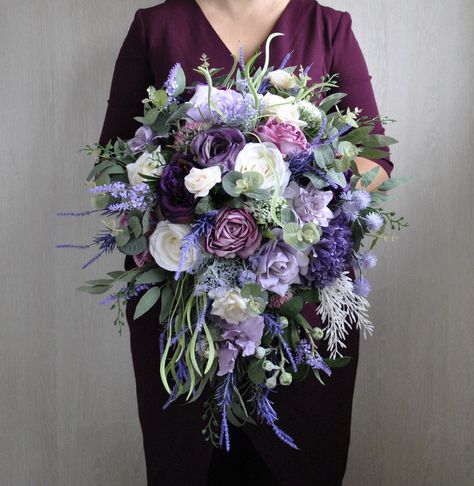 This purple lavender bridal  bouquet , cascading bouquet  is perfect for boho wedding,lavender wedding and elegant wedding,fall rustic wedding. Mixture of silk flowers lavender, ivory,purple,deep purple. Handle tied with velvet ribbon. Bridesmaid lilac flowers bouquet. Is made of high quality artificial flowers and greenery. The colors may slighty differ due to your screen settings. Black And Purple Bouquet, Purple Wedding Flower Arrangements, Lilac Purple, Navy And Lavender Wedding, Royal Purple Wedding, Wisteria Wedding, Lavender Bridal Bouquet, Fall Purple, Purple Bouquets