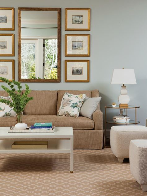 Light blue walls are paired with neutral furniture and accessories for a light, airy living room. To add visual interest to the neutral furnishings, a variety of textures and patterns is used. Blue Couch Living, Light Blue Living Room, Brown And Blue Living Room, Blue Walls Living Room, Blue Couch Living Room, Tan Sofa, Blue Bedroom Walls, Light Blue Walls, Blue Living Room Decor