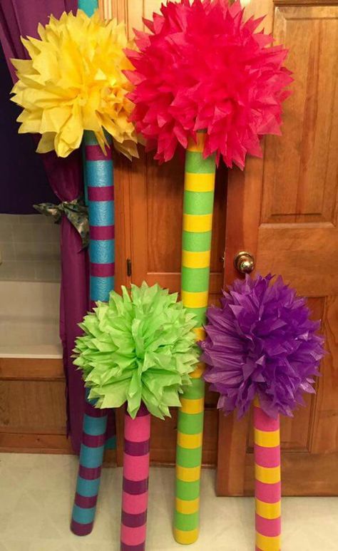 It's pool noodles, duct tape, and tissue paper flowers 😊 Dr.  Seuss theme Dr Suess Flowers, Vbs Garden Theme, Tissue Paper Parade Float, Pool Noodle Flowers, Dr Seuss Flowers, Lorax Photo Booth, Dr Seuss Backdrop Ideas, Dr Suess Backdrop, Oh The Places Youll Go Decorations