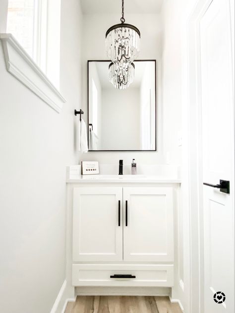 White and black powder room #chandelier #powderroomideas #guestbathroomideas #bathroomdecor #bathroomideas Clean Powder Room Ideas, White And Black Powder Room Ideas, Black White Gray Powder Room, Small Powder Room White Vanity, Powder Bathroom White Vanity, Guest Room Ideas Black And White, Small Powder Room Ideas Black And White, White Vanity Powder Room Ideas, Powder Room White Vanity Black Hardware