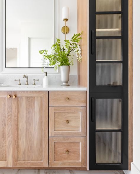 From custom stained cabinets to sleek black doors with reeded glass, every detail in this master bathroom reflects thoughtful design. The stained wood adds warmth, while the reeded glass doors introduce texture and privacy without sacrificing style. Need help bringing your master bath vision to life? Reach out to us – we would love to work with you!  Builder: Maxey Homes  Design: @hawkinsandgraydesign  Photos: @lyndseymariephotography  Cabinetry: @elite_millworks Gray Stained Wood, Stained Cabinets, Door Privacy, Reeded Glass, Staining Cabinets, Black Door, Privacy Glass, Grey Stain, Stained Wood