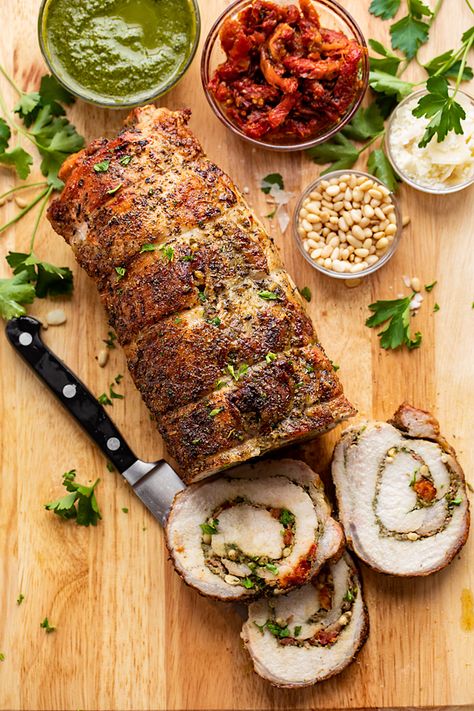 This succulent stuffed pork loin is brimming with pesto sauce, pine nuts, crispy pancetta, sun-dried tomatoes and parmesan! | thecozyapron.com #stuffedporkloin #stuffedporkloinrecipes #stuffedporkloinrecipesoven #stuffedporkloinroast #stuffedporkloinrecipesovenbaked #stuffedporkloinroastinoven #stuffedporkloinroastrecipes Stuffed Pork Loin Recipes Cream Cheese, Spinach Stuffed Pork Loin, Cheese Stuffed Pork Tenderloin, Pesto Pork Loin, Pork Loin Stuffed With Pesto And Prosciutto, Pork Loin Roast Recipes, Pork Loin Recipes, Pork Dinner, Pork Loin Roast