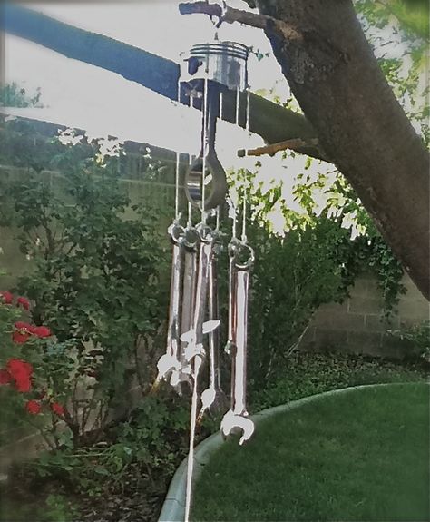 My husband made this wind chime out of an old piston and a set of wrenches. Wrench Wind Chime, Chimes Diy, Tool Crafts, Piston Art, Suncatchers Diy, Crystal Suncatchers Diy, Welded Art, Old Car Parts, Wind Chimes Homemade