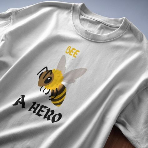 "Bee A Hero" : A Round Neck Half Sleeve T-Shirt For Men & Women Order Now : https://frolic-drip.blinkstore.in/product/BPD-6338-9CD5-485F Spelling Bee Shirt Ideas, Bee Tshirt Ideas, Boo Bees Tshirt, Honey Bee Tshirt Design, Yellow Short Sleeve T-shirt With Sunflower Design, Order Now, Half Sleeves, Round Neck, Bee