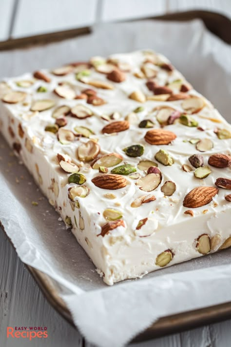 This Torrone recipe is simple, delicious, and full of nuts! A traditional Italian nougat that’s easy to make and perfect for sharing during the holidays. Diy Nougat Recipe, Dairy Free Italian Dessert, Easy Nougat Recipe, Roman Nougat Recipe, Soft Nougat Recipe, Italian Torrone Recipe, Nougat Recipe Easy, Italian Nougat Recipe, Torrone Recipe Italian