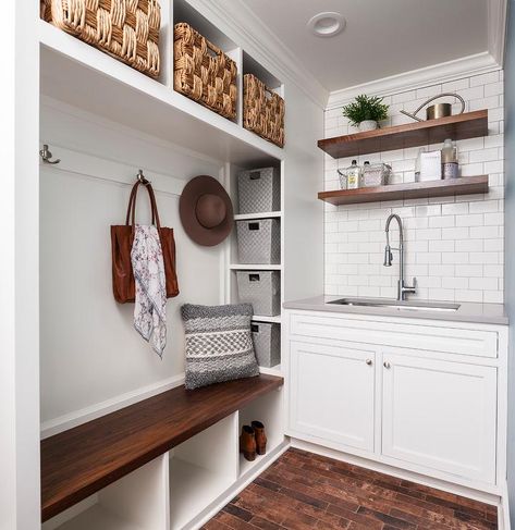 Two-toned mudroom/laundry room design featuring a white built-in mudroom bench with upper cubbies fitted with seagrass bins over a darkly stained bench and open shelves. Mudroom With Sink, Large Floating Shelves, Shelves Nursery, Mudroom Inspiration, Hallway Shoe Storage, Interior Remodeling, Floating Shelves Ideas, Laundry Room Storage Shelves, Small Laundry Room Organization