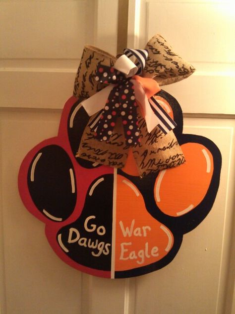 House divided paw. Georgia Bulldogs and Auburn Tigers. Can do any team you want. Get yours for football season. Starting at $30. Tiger Paw, Tiger Football, Geaux Tigers, Wooden Door Hangers, Classroom Door, Auburn Tigers, Door Hanger, Auburn, Door Hangers