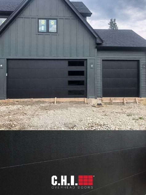 Add moody tones and a sleek, modern look to your home with Skyline Flush by C.H.I. Overhead Doors. Perfect your look by customizing your window and glass designs. Order free color samples, request a quote, or find a C.H.I. dealer today. // via @justinthegaragedoorguy on Instagram for DJK Custom Homes Chi Black Garage Doors, Black Garage Doors With Windows, Black Garage Door With Windows, Houses With Black Garage Doors, Modern Garage Doors With Windows, Modern Black Garage Door, Modern Farmhouse Garage Doors, Barndominum Homes, Modern Garage Door