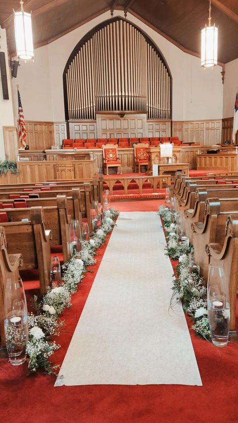 Garland sprinkled with babies breath and white flowers line the aisle of this church for my wedding. Babys Breath Aisle Flowers, Baby’s Breath Aisle, Wedding Aisle Baby Breathe, Church Aisle Decorations Wedding, Small Church Wedding Decorations, White Flowers Lining Aisle, Church Wedding Decorations Aisle, Small Church Weddings, Simple Church Wedding