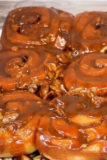 Sticky Puppies are caramel pecan sticky buns that are made with frozen cinnamon rolls and homemade buttery caramel sauce. By using quick-rise rolls, you can make these delicious Caramel Cinnamon Rolls in about 30 minutes. Time to eat! | Caramel Pecan Cinnamon Rolls | butterscotch cinnamon rolls | butterscotch pudding rolls | caramel sticky rolls | Caramel Cinnamon Rolls | Caramel Breakfast Rolls | #breakfast #brunch #sweets #caramel #cinnamonrolls Best Caramel Rolls Recipe, Pecan Cinnamon Rolls Recipe, Frozen Cinnamon Rolls, Caramel Pecan Cinnamon Rolls, Frozen Bread Dough Recipes, Maple Bacon Cinnamon Rolls, Caramel Cinnamon Rolls, Caramel Pecan Sticky Buns, Easy Sticky Buns