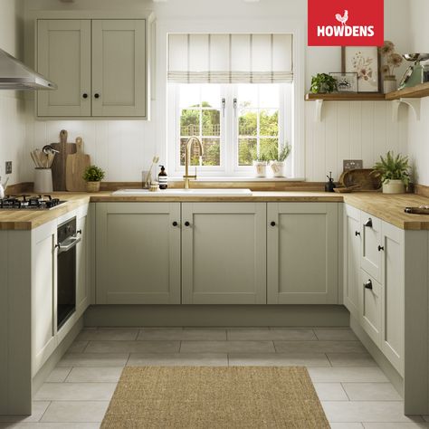 Introducing the stunning Howdens Halesworth Sage Green Kitchen. Perfect for traditional kitchen designs, these shaker-style green kitchen cabinets add a touch of elegance to any space. Pair them with oak kitchen countertops for a cohesive look that's both timeless and practical. The U-shaped kitchen design offers ample storage and workspace, making it perfect for busy families and home chefs. Trust us, this kitchen is a stylish and functional choice that you won't regret. Kitchen Floor With Green Cabinets, Light Sage Kitchen, Light Sage Kitchen Cabinets, Green Kitchen Cupboards, Sage Green Kitchen Cabinets, Open Shelving Kitchen, Light Green Kitchen, Green Kitchen Island, Howdens Kitchens