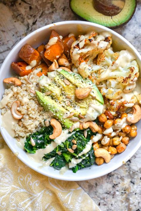 Hearty & delicious vegan buddha bowls are made with quinoa, cauliflower, sweet potato, chickpeas, spinach & drizzled with an easy hummus dressing. Sweet Potato Chickpeas, Vegan Buddha Bowls, Cauliflower Sweet Potato, Potato Chickpea, Vegan Buddha Bowl, Healthy Bowls Recipes, Buddha Bowls, Healthy Bowls, Vegan Bowls