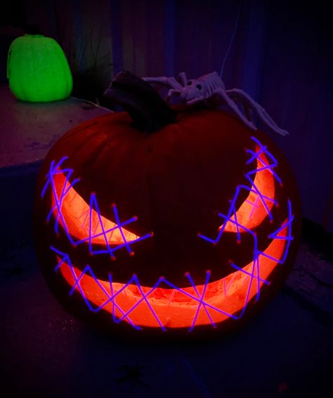 I used uv reactive yarn to thread across the eye and mouth openings on the pumpkin. Hung a black light, and voila! Pumpkin With Mouth Sewn Shut, Eye Pumpkin Carving, Pumpkin Mouth, Pumkin Carving, Creative Pumpkin Carving, Amazing Pumpkin Carving, Glow Paint, 2024 Halloween, Creative Pumpkins