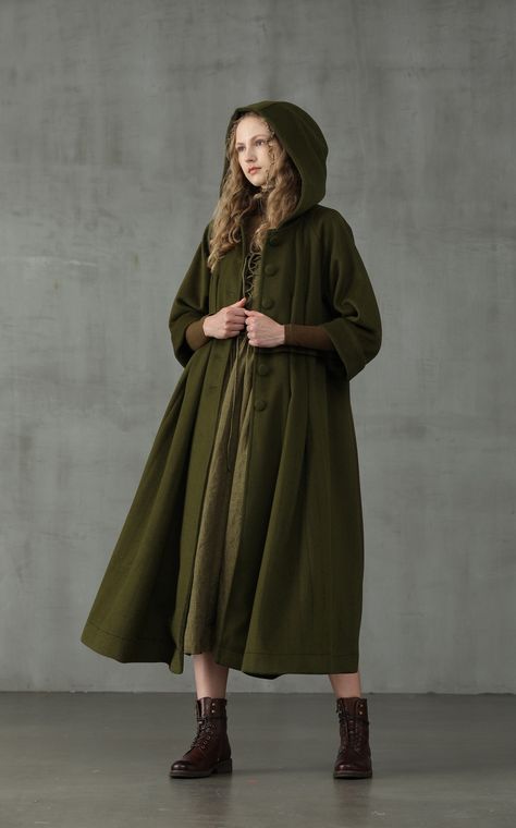 Embrace your sophisticated side with Linennaive Playing with proportions and details, we presents a new take on the classic 100% wool coat for our winter collection.  It is given an unique look with its oversized hood and napping 100% wool in moss green.  With deep side pockets and handmade pintucks all over the coat, it is cut for a mid-length and creates a striking voluminous silhouette.  We are sure this coat will make colder weather your favourite forecast.  Ensure that your outerwear is the Red Apron, Hooded Wool Coat, Cashmere Cape, Cozy Coats, Wedding Cape, Green Retro, Linen Fashion, Coat Winter, Comfort Wear