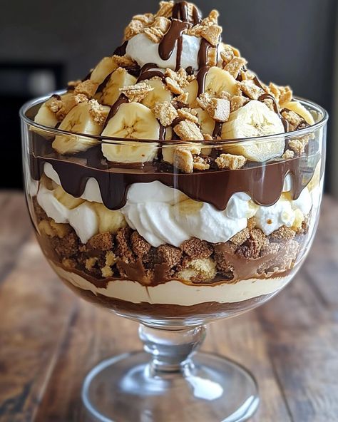 🍫 Chocolate Peanut Butter Banana Cream Trifle 🍌🥜 Layers of chocolate, peanut butter, and bananas come together in this creamy, decadent trifle! Ingredients: For the Chocolate Layer: 1 box (3.9 oz) instant chocolate pudding mix 2 cups cold milk For the Peanut Butter Layer: 1 cup creamy peanut butter 8 oz cream cheese, softened 1 cup powdered sugar 1 teaspoon vanilla extract 1 cup whipped cream or whipped topping For the Banana Layer: 3-4 ripe bananas, sliced For the Whipped Cream: 1 cup... Banana Cream Trifle, Peanut Butter Banana Recipes, Trifle Dessert Recipes, Ripe Bananas, Peanut Butter Recipes, Banana Cream, Banana Recipes, Fun Baking Recipes, Peanut Butter Banana