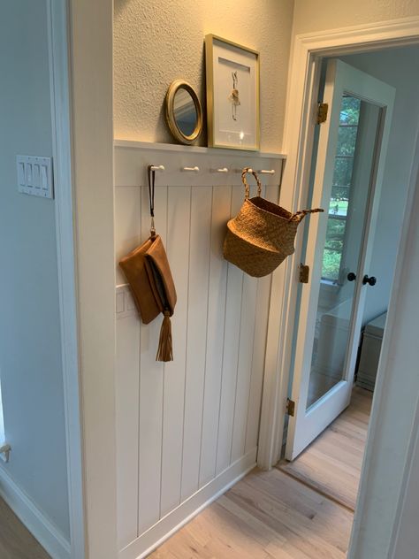 Easy project using vertical shiplap, 1*5’s and pegs. Vertical Shiplap With Peg Rail, Vertical Shiplap Board And Batten, High Traffic Wall Covering, Vertical Shiplap With Shelf, Wainscoting With Peg Rail, Hallway Panelling Tongue And Groove, Shaker Peg Rail Entryway, Vertical Shiplap Hallway, Vertical Shiplap Entryway