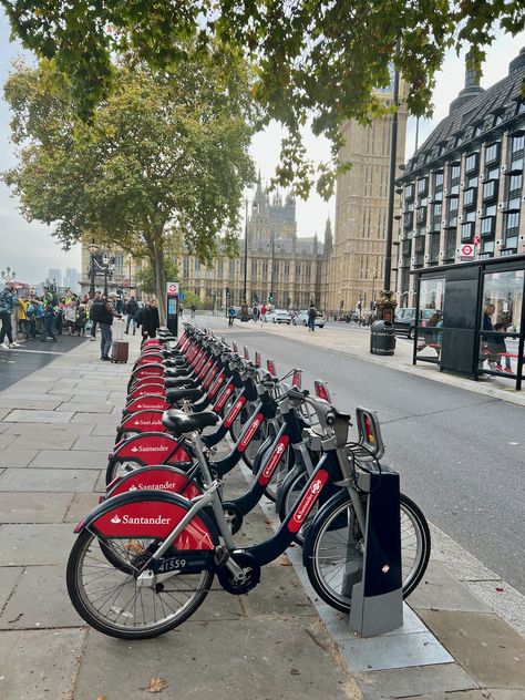 Santander Cycles (aka Boris Bikes) are a fun, healthy and sustainable way to get around London and pictured here are a bank of them near Westminster Bridge and the Palace of Westminster. This public bicycle hire scheme is managed by Transport for London and pay as you go cost £1.65 for up to 30 minutes. Photo Credit: © Ursula Petula Barzey. #BlueBadgeTouristGuide #LetsDoLondon #VisitLondon London Public Transportation, Public Transport Aesthetic, Newspaper Pictures, Cycling In London, Country Core, Palace Of Westminster, London Sights, London Vibes, Bike Pictures