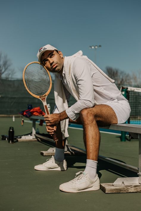 Man sitting on a be shot at a tennis court getting ready to play Tennis Men Photoshoot, Male Tennis Photoshoot, Tennis Racket Photography, Strings Photoshoot, Tennis Portrait Photography, Tennis Court Photoshoot Men, Sport Photography Ideas, Tennis Poses Photo Ideas, Tennis Pictures Poses