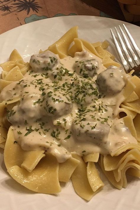 Looking for dinner ideas? Try cooking this quick meatball stroganoff. Use cream of mushroom soup, beef meatballs, sour cream, and egg noodles to cook this easy stroganoff recipe for dinner! Meatball Stroganoff Recipe, Quick Meatballs, Hamburger Stroganoff, Meatball Stroganoff, Sour Cream Sauce, Buttered Noodles, Stroganoff Recipe, Cream Of Mushroom Soup, Meatballs Easy