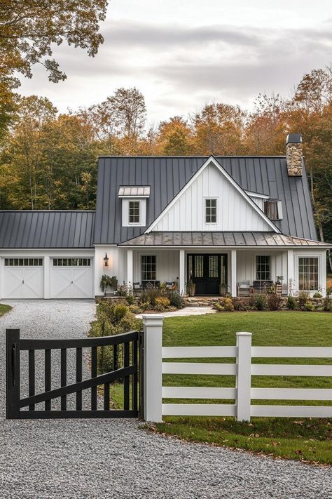 Wide angle view of a modern farmhouse exterior in white board and batten siding black multi pitched roof with dormers brown stone chimney detached. Check out all of these dream farmhouses that will have you drooling with rural living fantasies and mooing with joy! Farmhouse Exterior Bungalow, Modern Day Farmhouse Exterior, Modern Farmhouse Metal Roof, White House With Charcoal Metal Roof, Ranch To Farmhouse Exterior, White Farmhouse Metal Roof, White Farmhouse Black Roof, Board And Batten Siding With Black Windows, White House Black Trim Wood Accents Exterior Farmhouse