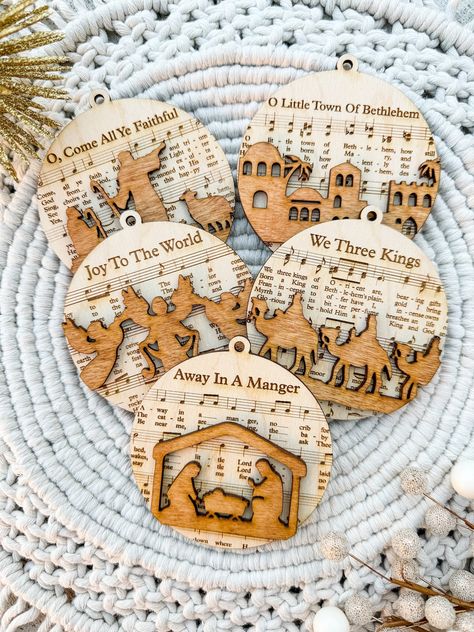 Enhance your holiday decorations with this Custom Laser Cut Wooden Nativity Scene Ornament Set. These ornaments combine the beauty of a nativity scene with the magic of Christmas music, making them a unique and cherished addition to your festive decor. Whether for your own home or as a thoughtful gift, these ornaments are sure to bring joy and warmth to your holiday celebrations. Buy as a set of 5 or individual ornaments! Easy Christian Christmas Crafts, Christian Crafts To Sell, Religious Christmas Crafts, Sheet Music Ornaments, Wooden Nativity, Christmas Bazaar, Religious Ornaments, Music Ornaments, Christian Ornaments