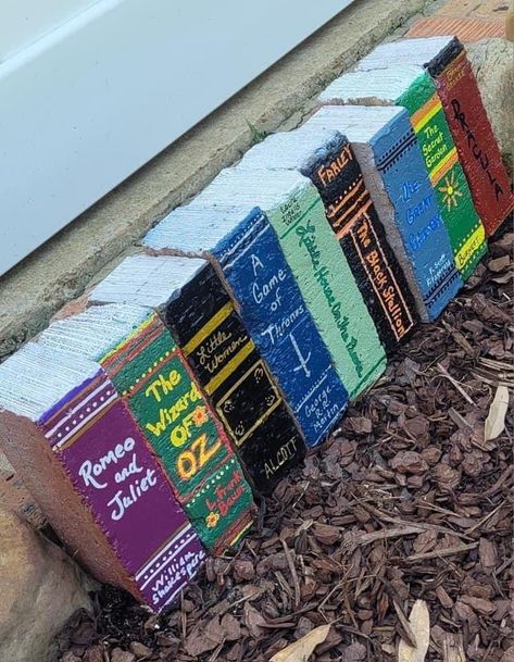 Bricks painted to look like books Paint Bricks To Look Like Books, Diy Brick Books, Bricks Painted As Books, Painting Bricks For Garden, Painted Bricks To Look Like Books, Book Bricks Diy, Garden Brick Books, Painted Garden Bricks, Book Bricks Garden